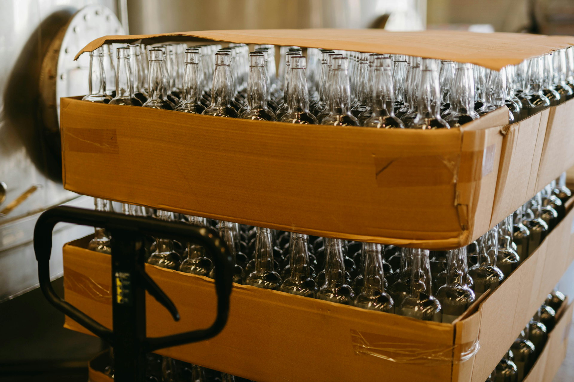 Empty glass bottles staged for a Small Batch Co-Pack production run